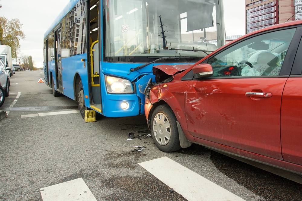 Head-on collision between a car and a bus at a pedestrian crossing. Traffic accident