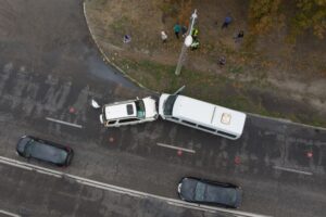 Severe accident scene. Aerial view of a car crash. Head-on collision between two vehicles.