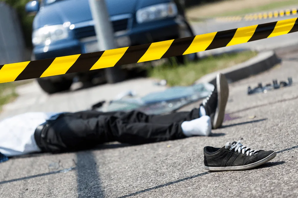 a person who got hit by a car, lying on a road
