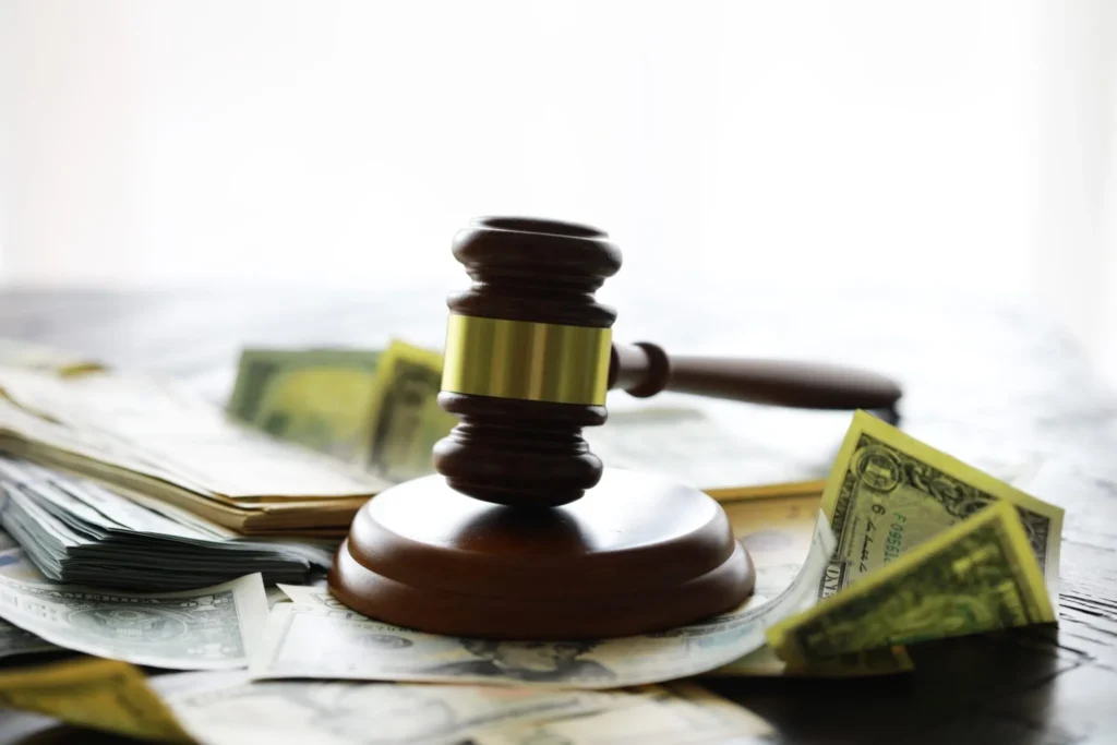 a gavel on top of a bunch of money papers