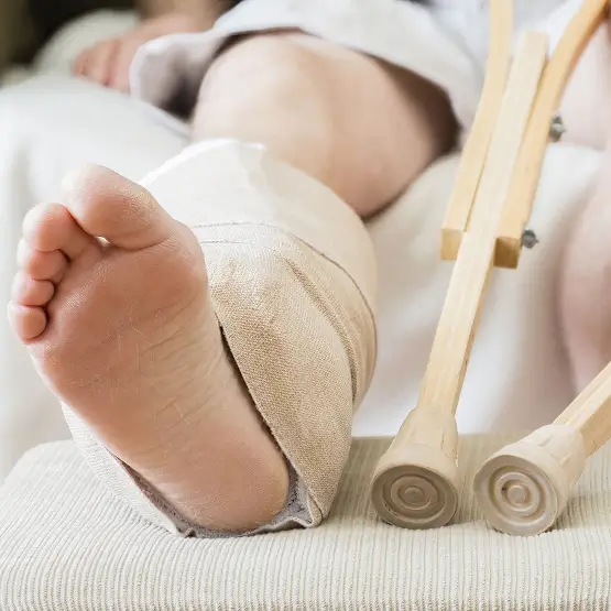 a person with a cast and crutches