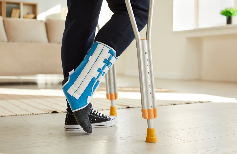 leg of man walking with crutches