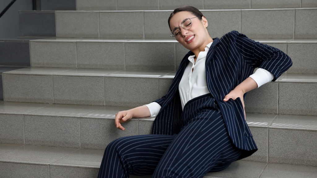 woman experiences back pain after fall