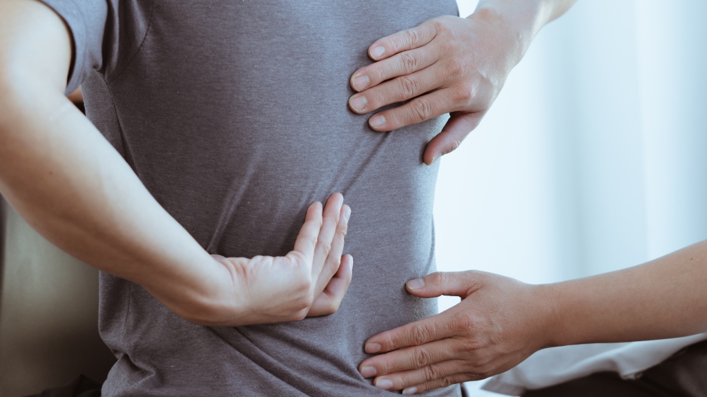 Doctor examines back pain after Slip and Fall accident