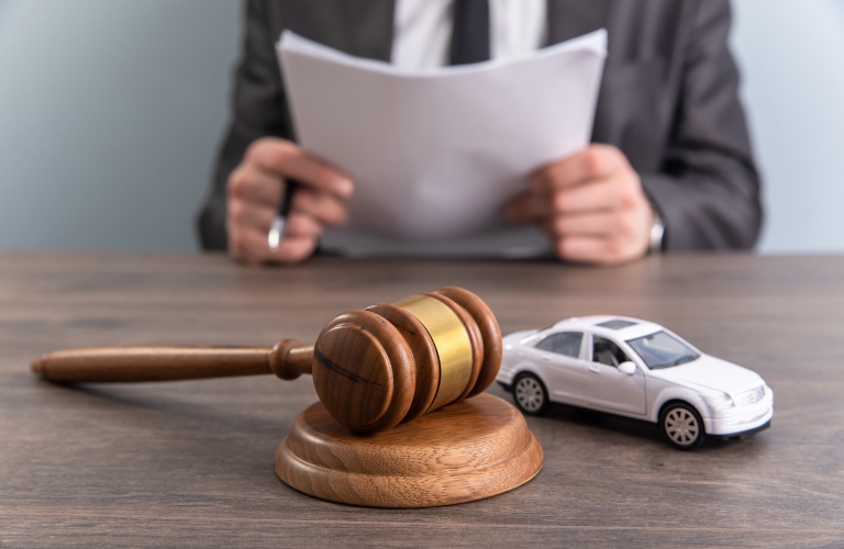 Model of car and gavel