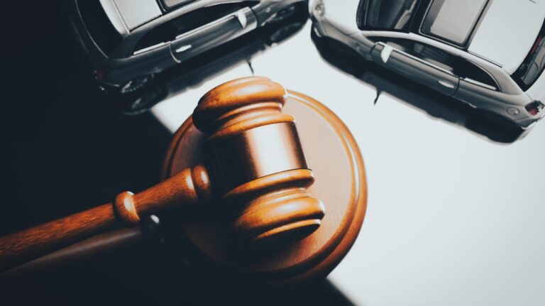 Model of car and gavel
