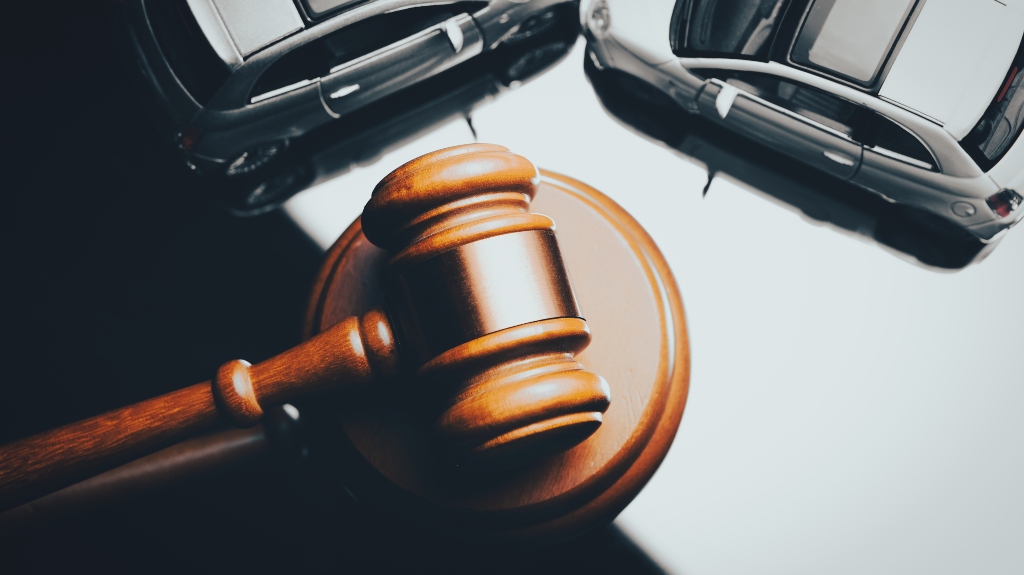 Model of car and gavel