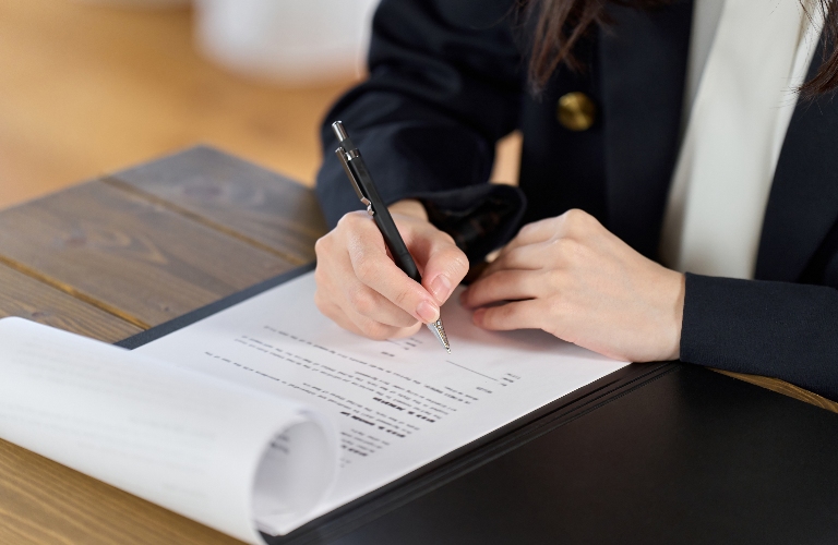 female lawyer is signing documents