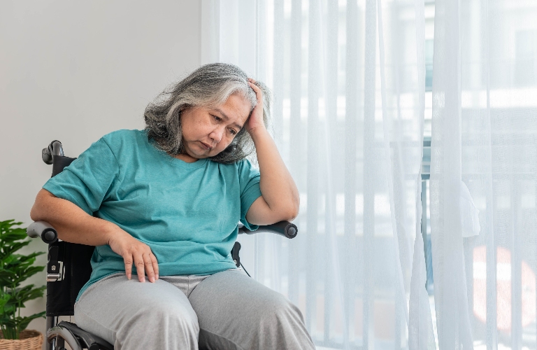 sad elderly woman patient is sitting on wheelchair