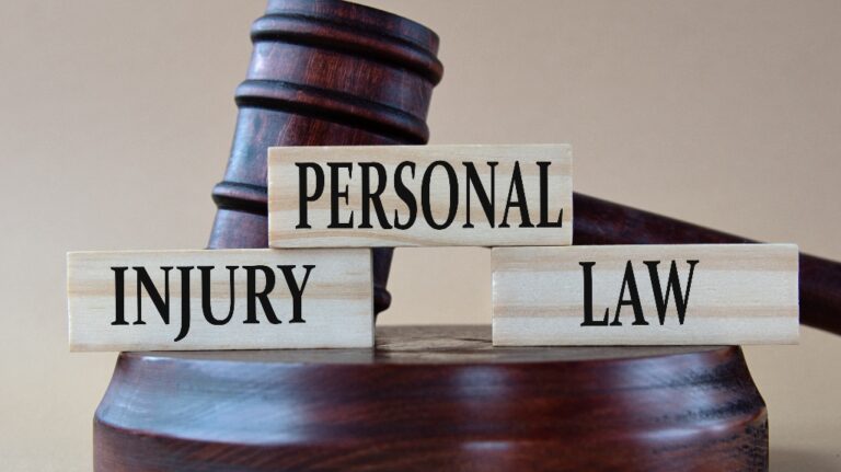 Personal Injury Law - words on wooden blocks against the background of a judge's gavel