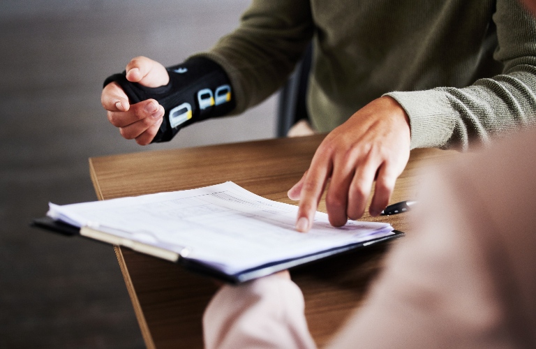 lawyer is consulting client with hand injury