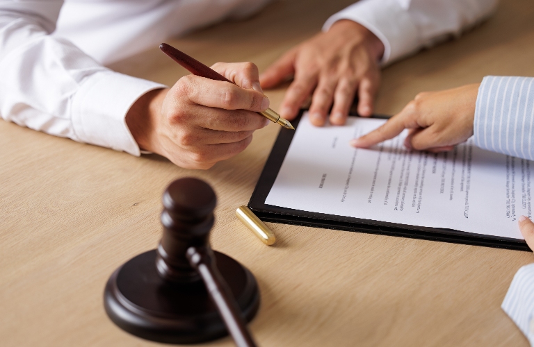 lawyer is showing client where to sign document