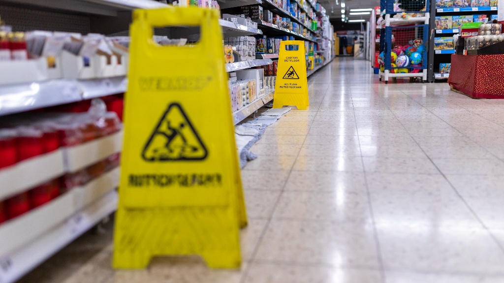 Stand for risk of slipping on slippery floors at grocery shop